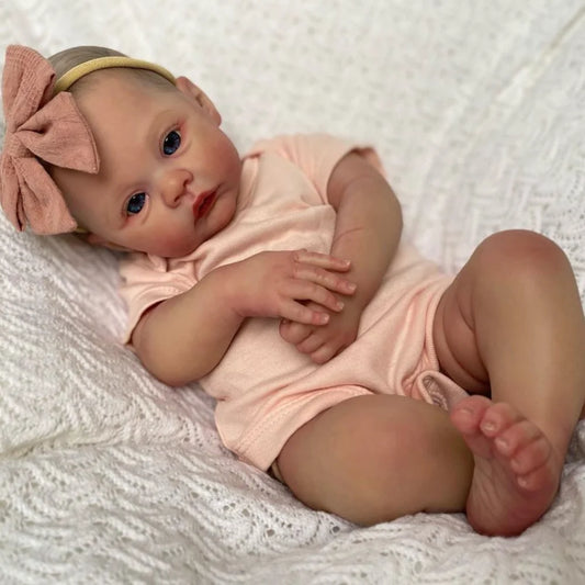 Full vinyl body reborn doll dressed in newborn clothes