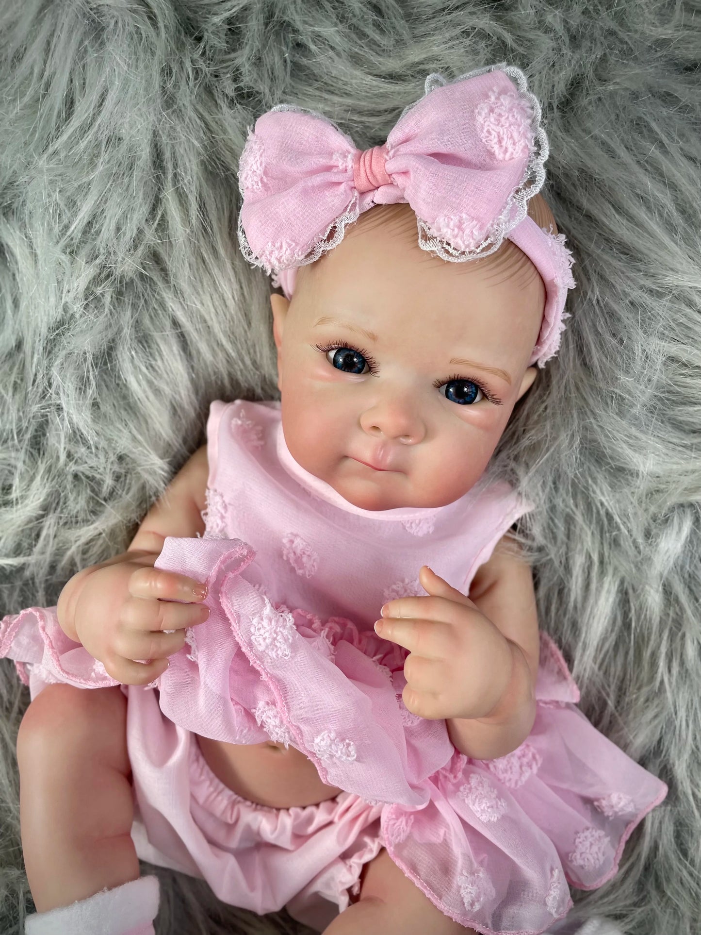 Full body washable vinyl reborn doll wearing baby clothes