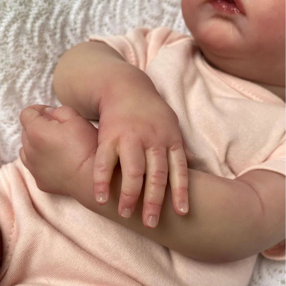 Reborn Doll gift set including doll, clothes, bottle, and birth card.