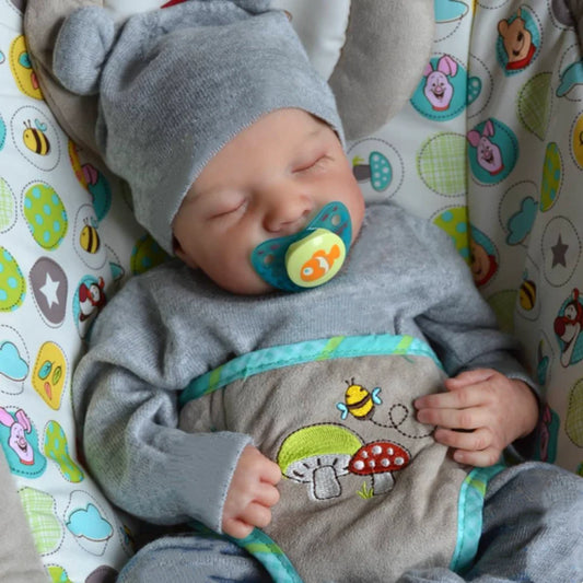 46 cm Reborn Baby Doll Levi in realistic outfit lying in crib